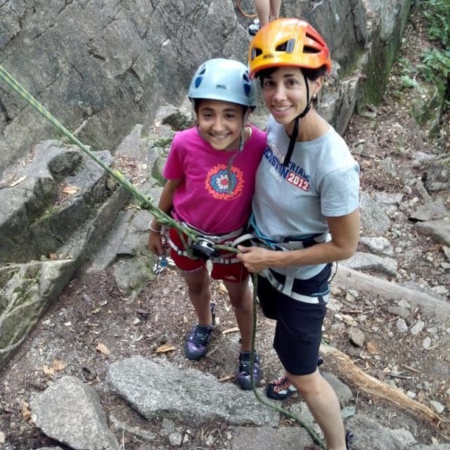 Family rock climbing instruction at Cathedral Ledge in North Conway, New Hampshire.