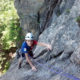 Family rock climbing on Upper Refuse at Cathedral Ledge, New Hampshire.