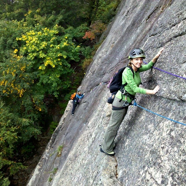 Guided rock climbing the traverse on Thin Air at Cathedral Ledge, New Hampshire.